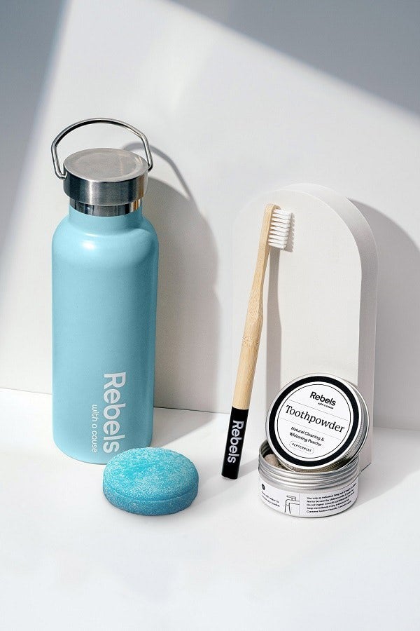 Reusable bottle, bamboo toothbrush, shampoo bar, toothpowder