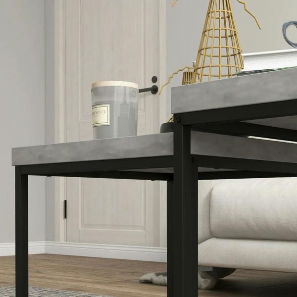 Corner close-up of grey tabletop and black steel frame of the nesting coffee table set