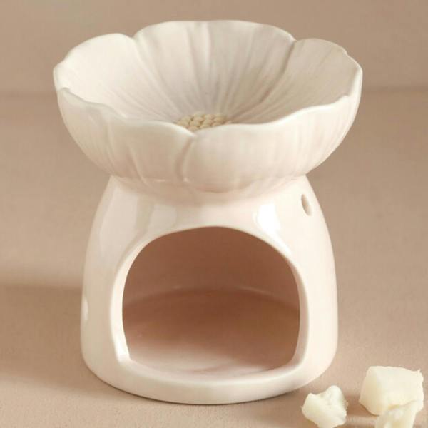 Front view of the unlit Pink Blossom ceramic wax melt burner with sculpted flower dish and wax melt pieces on a warm neutral background by Abode Home & Gifts