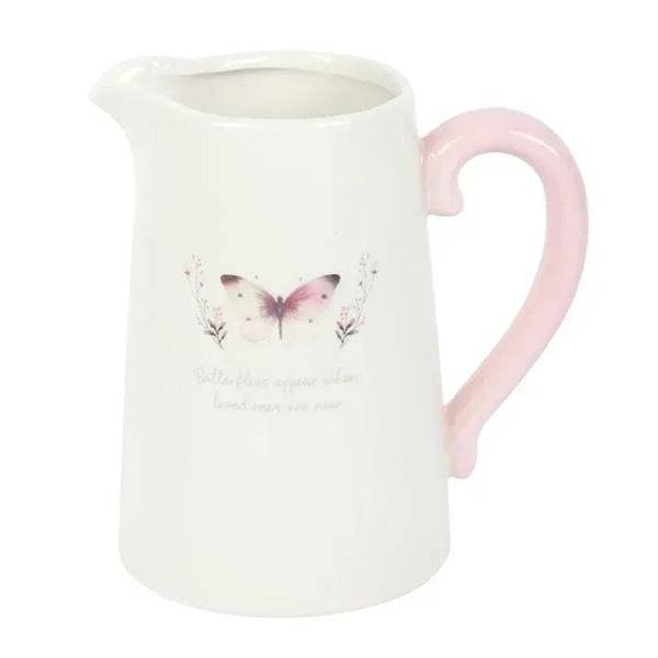White ceramic flower jug with pink handle and centered butterfly print