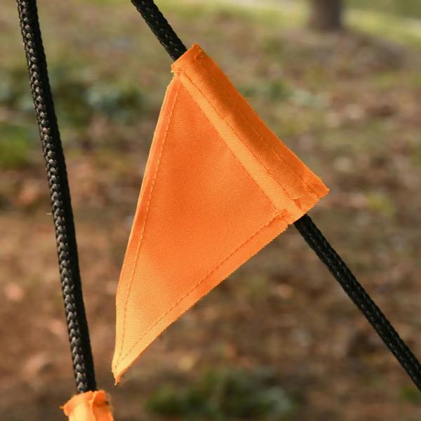 Orange fabric triangular flag on black hanging swing rope