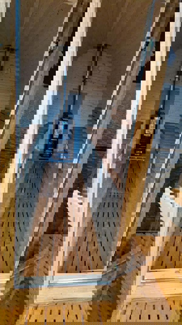 Barrel sauna interior with benches and stove