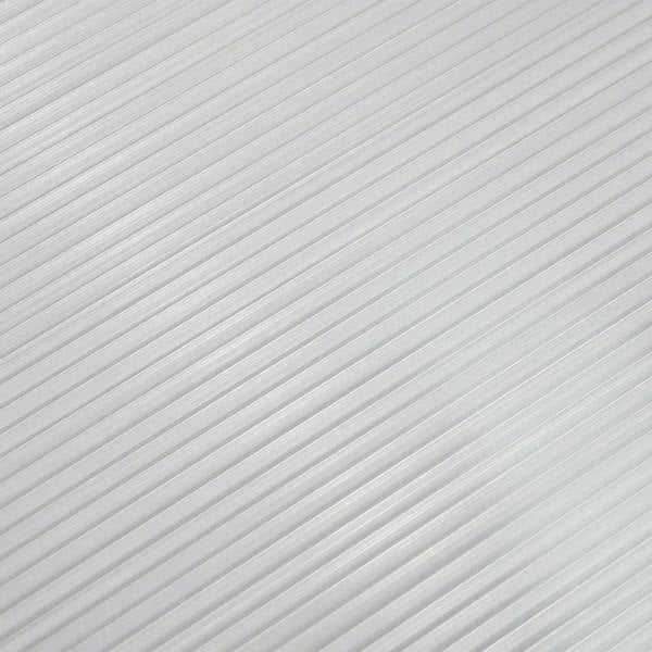 Close-up of clear twin-wall polycarbonate sheet texture with parallel ridges