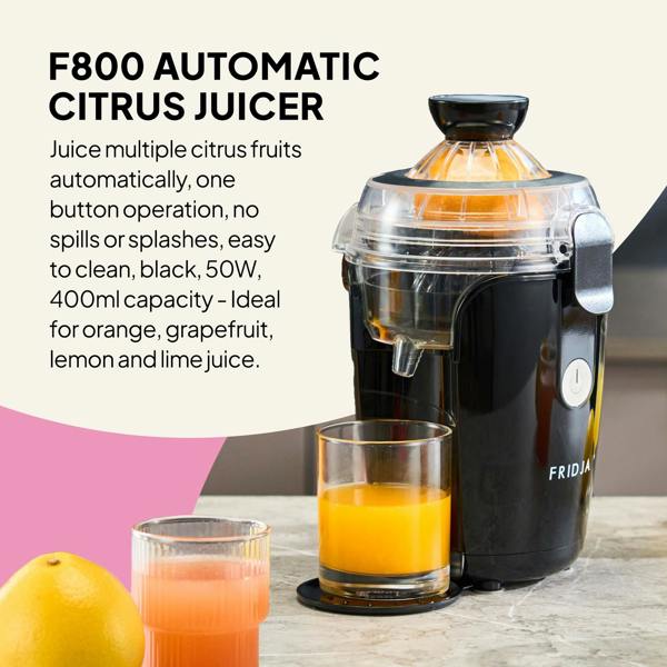 A Fridja f800 Automatic Citrus Juicer in black sits on a table next to a glass of fresh juice and a halved orange, with features and benefits displayed on the left side of the image.