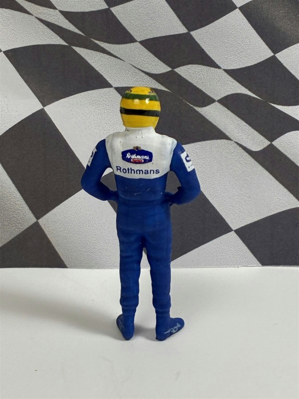 a toy figure of a race car driver