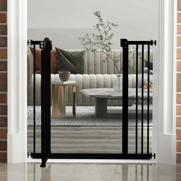 Black adjustable pet safety gate with auto-close door installed in an indoor doorway