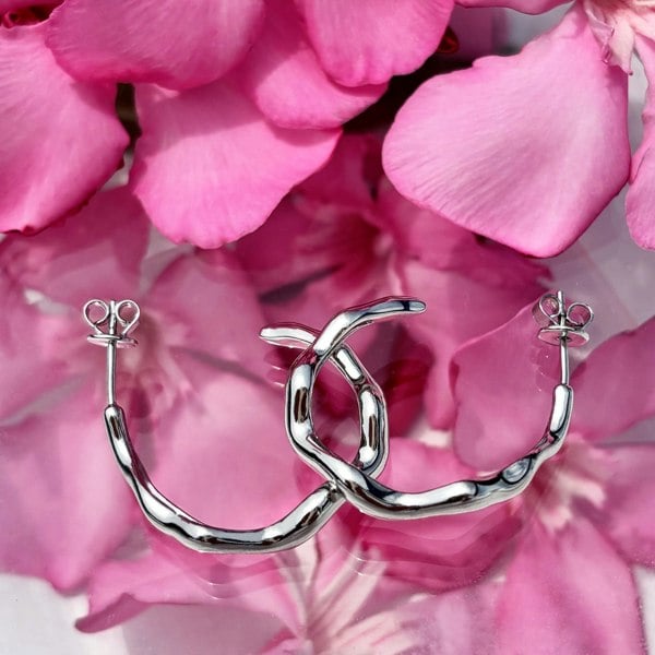 Liquid silver hoops by LENAE London, sculptural design.