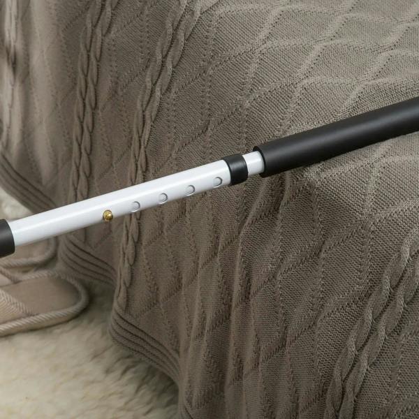 Close-up of white grab bar with black grip section and height adjustment holes