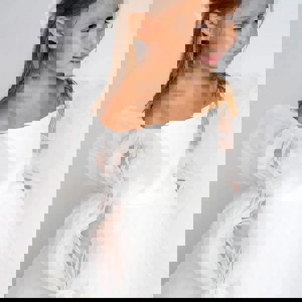 Pretty girl smiling in Etoile white dress