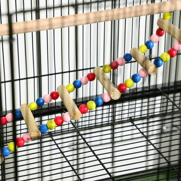 Bird cage interior with colorful bead ropes and wooden perch swing on bars