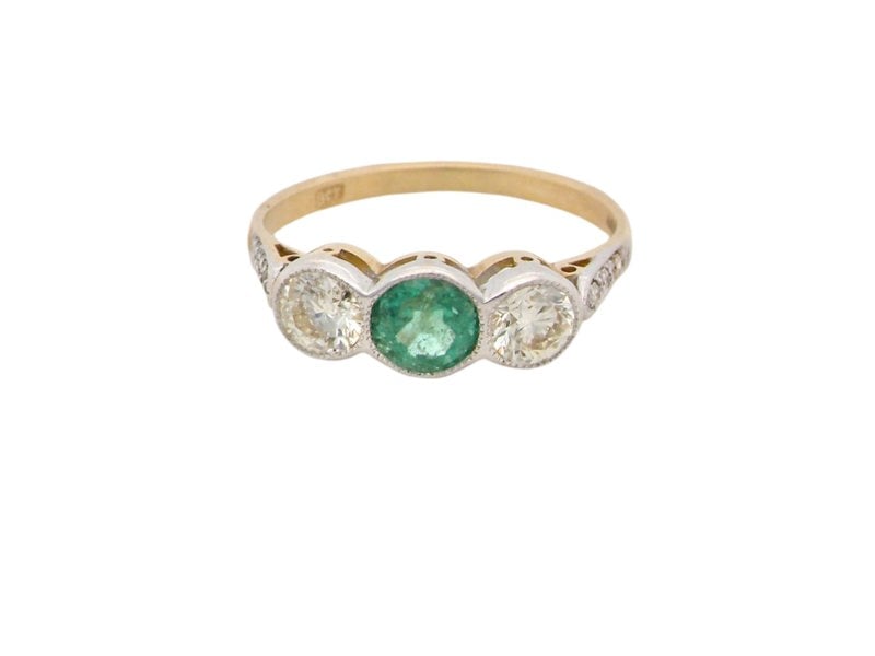 An Emerald and Diamond 3 stone ring