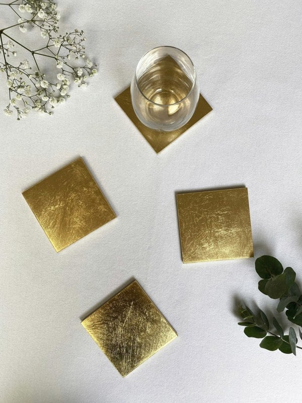 gold leaf coasters arranged on a white surface