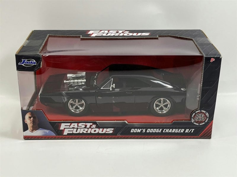 a black toy car in a box