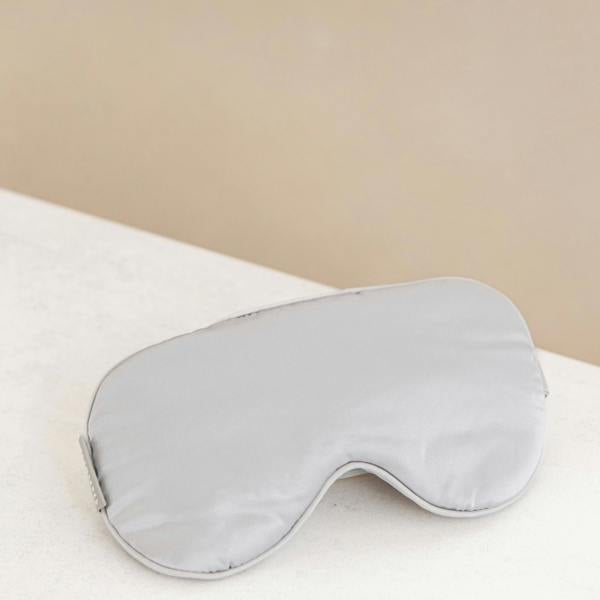 Silver sleep mask on display.
