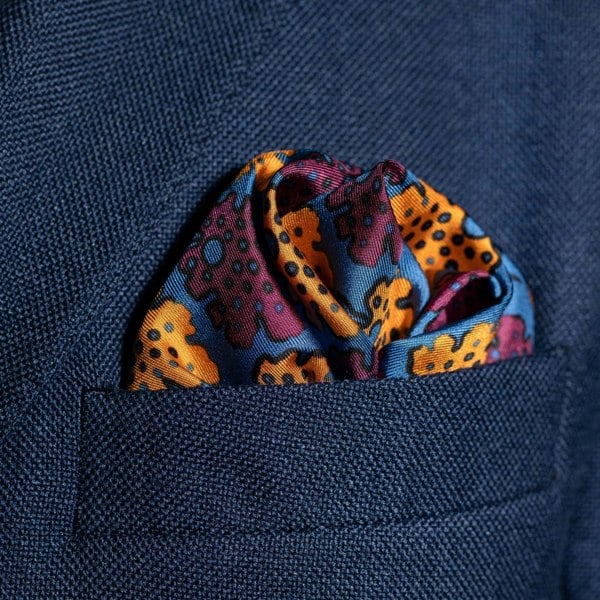 Leaf design silk pocket square in blue, burgundy & gold by Otway & Orford folded in top pocket