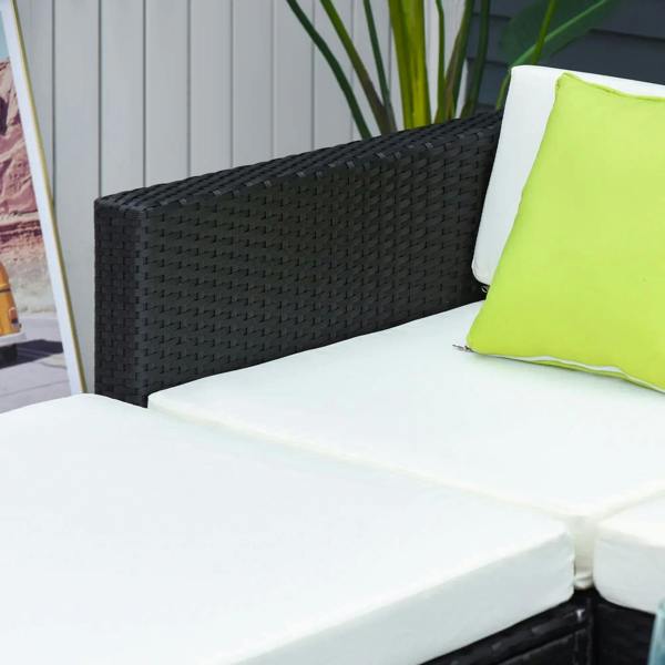 Black rattan sofa armrest with white cushions and lime green pillow