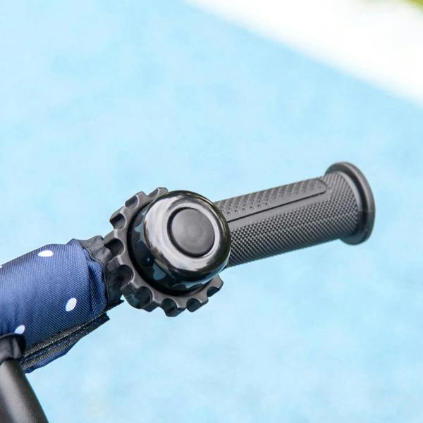 Dark blue kids tricycle handle grip close-up with textured rubber handlebar