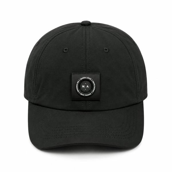 Black Marshall Artist Siren nylon ripstop baseball cap with a central circular M.A. logo patch on the front.