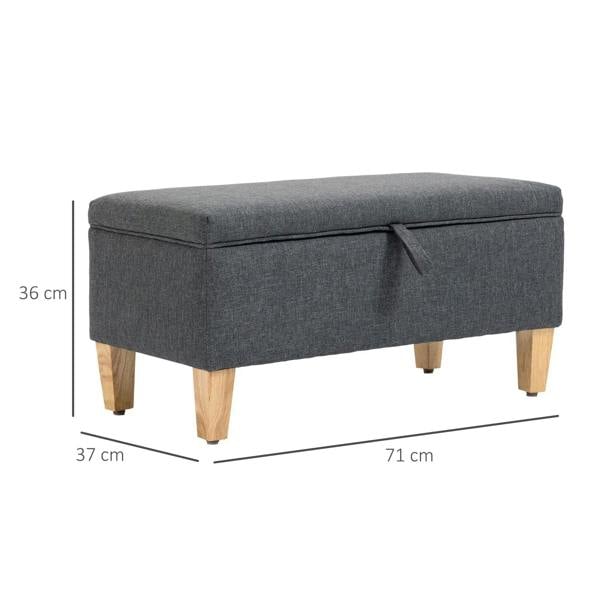 Dark grey storage ottoman with padded hinged lid and light wood legs, size shown