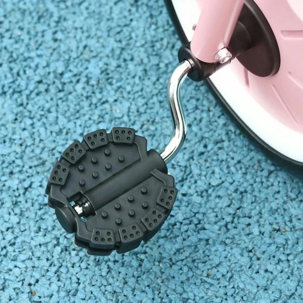 Pink kids tricycle bell and handlebar detail, black bell housing