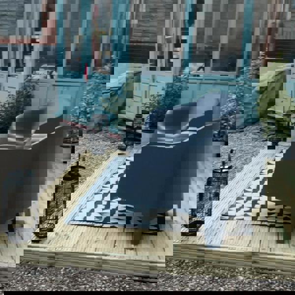 Outdoor seating area with chairs and lantern on deck