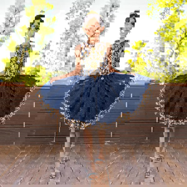 Girl in a crown wearing a beautiful navy and gold sequin dress