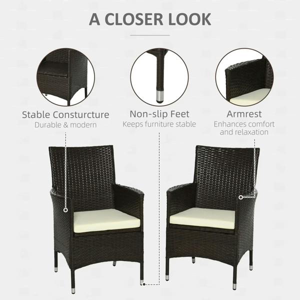 2 dark rattan dining chairs with cream seat cushions, armrests, and stable feet