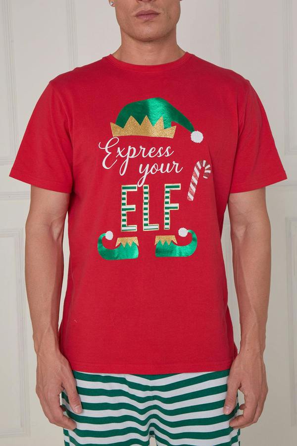 Person wearing a red t-shirt with Christmas-themed design and green striped pants.