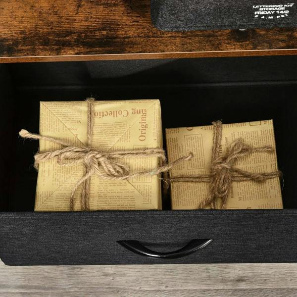 Gray fabric drawer of a TV stand cabinet holding wrapped storage items