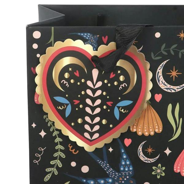 Medium black gift bag with Midnight Bloom heart emblem, flowers and moons; black rope handle