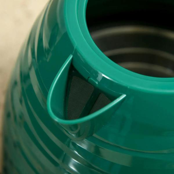 Green kettle spout opening with removable mesh filter insert.