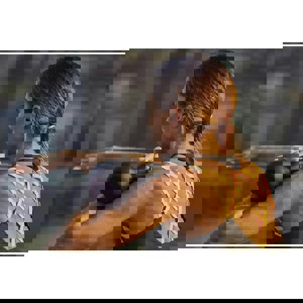 Woman exercising with an Adidas 4kg kettlebell