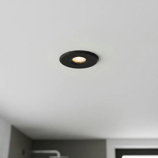 black waterproof recessed bathroom ceiling light installed in a modern bathroom