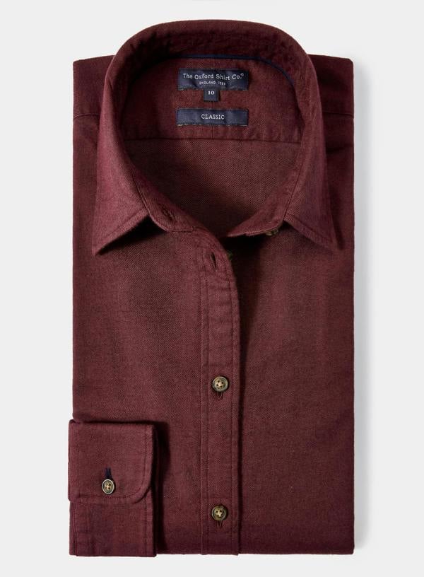 Maroon shirt with button details on a light gray background