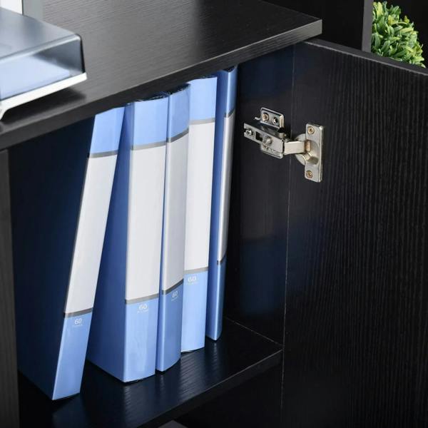 Close-up of black cabinet door hinge and lock area with labeled binders inside