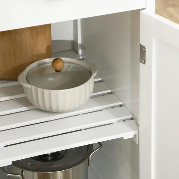 Inside open shelf on a white kitchen trolley cart for holding a small cooking pot