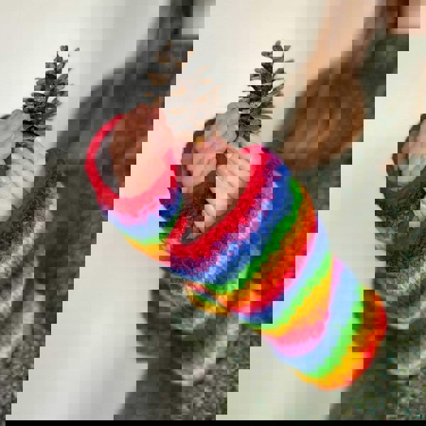 A girl wearing Woollen Rainbow Handwarmer Gloves.