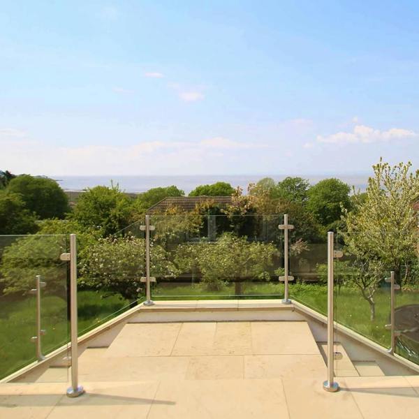 Stainless steel balustrade end post, 110cm high, features a sleek design with a polished finish, set against a scenic outdoor backdrop