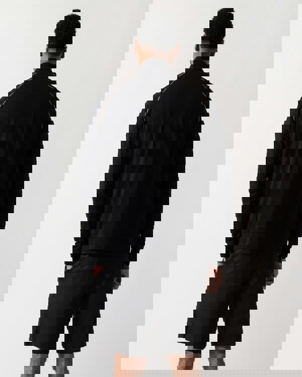 Back shot of a Model wearing a BOSS Orange Mix&Match Mens Logo-Embroidered Full Zip Loungewear Jacket in black Stretch-Cotton Jersey