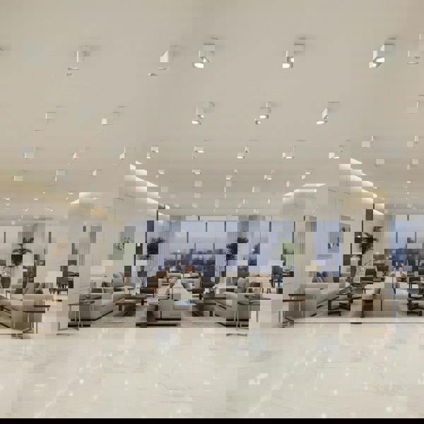 white semi flush ceiling light on the ceiling in a hotel reception area