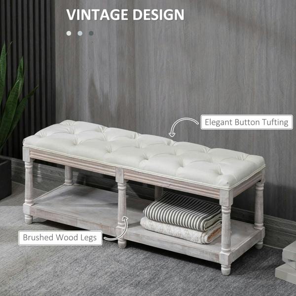 Cream button-tufted upholstered window seat bench with brushed wood legs and bottom shelf