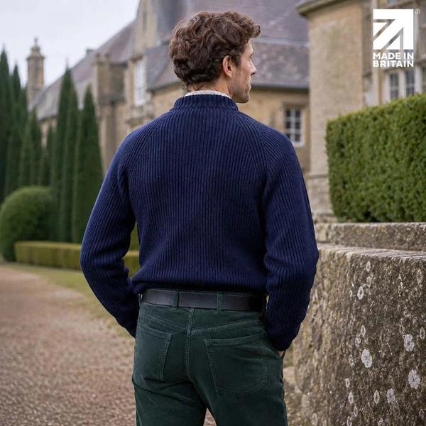 Rear view of a men’s black 40mm full-grain Italian leather belt worn with green trousers