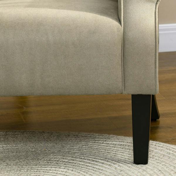 Beige upholstered armchair side view with dark wooden legs