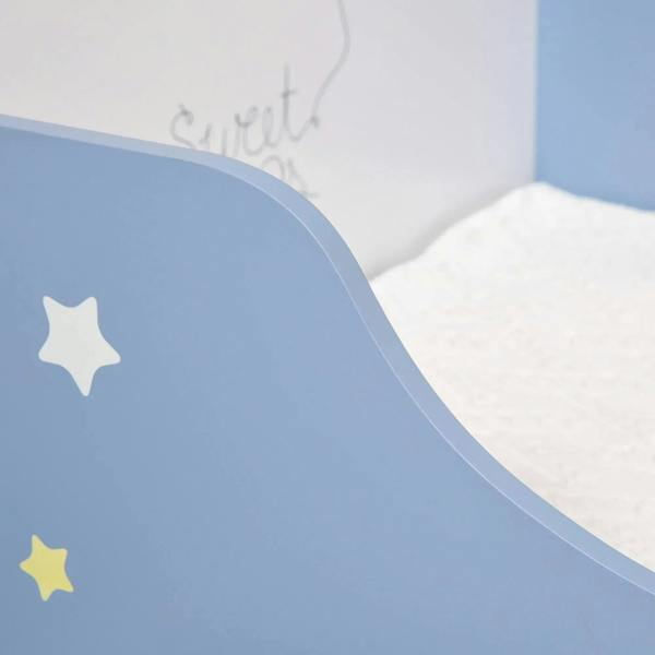 Close-up of blue toddler bed guardrail with star decals on the side panel
