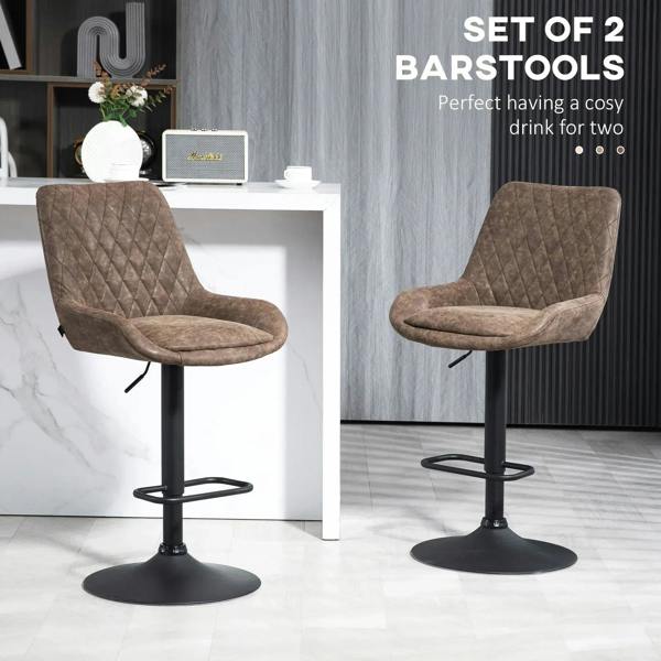Set of two brown faux leather bar stools with diamond tufting, curved seats, and black footrest