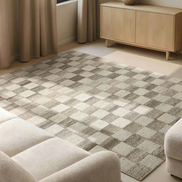 Living room with a checkered pattern rug, beige sofa, and wooden cabinet.
