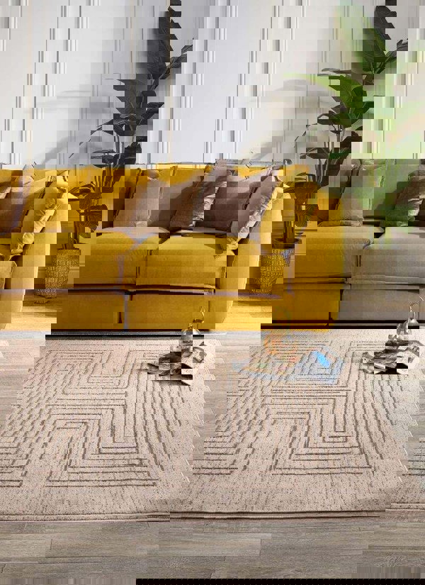 Abstract striped geometric rug in neutral tones under a yellow sofa, enhancing a modern living space.