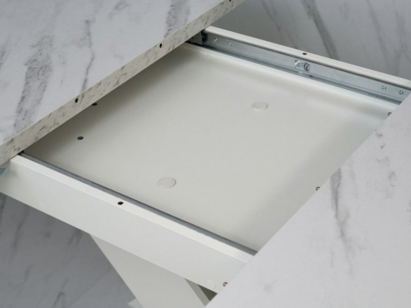 Detail of the extension system beneath the White Bianco marble effect tabletop of the dining table