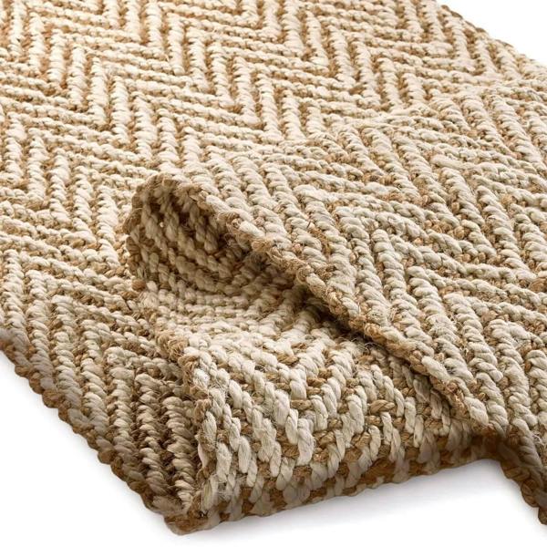Textured beige rug with a woven pattern on a white background