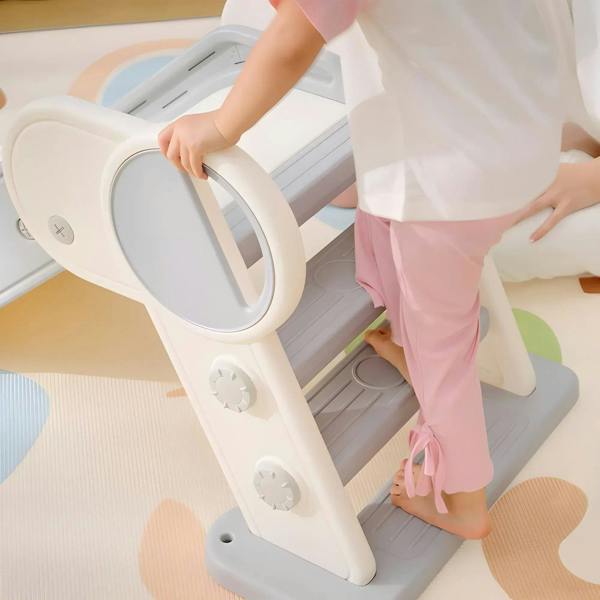 Close-up of toddler using a foldable kids slide step with circular side handrail